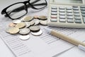 Coins, glasses, calculator and pen on savings account passbook Royalty Free Stock Photo