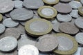 Coins of Great British sterling currency including cash and coins on plain back ground fifty pence and pound coins and other chang