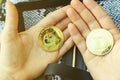 Coins in hands in close-up, Dogecoin cryptocurrency, gold tokens