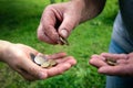 Coins in hands of two old man. Counting and sharing money Royalty Free Stock Photo