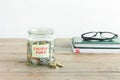 Coins in jar with College Fund label Royalty Free Stock Photo