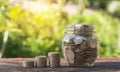 Coins in jar with money stack step growing money. Royalty Free Stock Photo