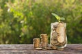 Coins in jar with money stack step growing money, Concept finance business and saving investment. Royalty Free Stock Photo