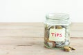 Coins in jar with Tips label Royalty Free Stock Photo