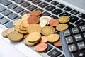 Coins on laptop keyboard and calculator close-up. Business concept. Royalty Free Stock Photo