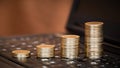 Coins on a laptop keyboard, money savings banner Royalty Free Stock Photo