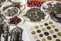 Coins, medals, badges and seeds at a table. The text in the poster means `Bank of Lebanon` Royalty Free Stock Photo