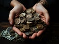 Coins in palms of woman hands over black background. Financial growth, saving money, investment concept Royalty Free Stock Photo