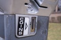 Classic metal parking meter cion slot in subburban area Royalty Free Stock Photo