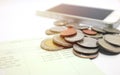 Coins and phone on account book bank for finance and banking. Royalty Free Stock Photo