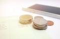 Coins and phone on account book bank for finance and banking. Business concept Royalty Free Stock Photo