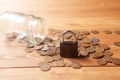 Coins are pouring from the piggy bank and the lock is on them. saving savings concept Royalty Free Stock Photo