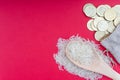 Coins and rice on red background. Zakat concept.