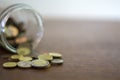 Coins spilling from a glass jar Royalty Free Stock Photo