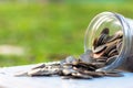 Coins spilling from a money glass jar Royalty Free Stock Photo