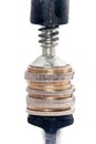 Coins squeezed in vise Royalty Free Stock Photo