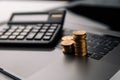 Coins stack with calculator on laptop. Grwoth business success concept. Royalty Free Stock Photo