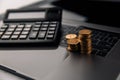 Coins stack with calculator on laptop. Grwoth business success concept Royalty Free Stock Photo