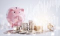 Coins stack and Happy Piggy  Bank in close-up and the light bulb with line graph  business connect on white background, Saving  id Royalty Free Stock Photo