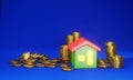 Coins stack and home on dark blue background Royalty Free Stock Photo