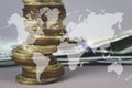 Coins stack and stack of one hundred dollar bills with Digital Earth planet Global world map symbol on grey background