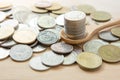 Coins stack on wooden spoon with sunlight  for money saving concept Royalty Free Stock Photo