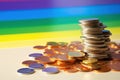 Coins stacked on each other in different positions, with rainbow background Royalty Free Stock Photo