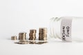 Coins stacked up next to an empty jar with a label on for pension fund. Pension, financial, savings, economy, investment concept Royalty Free Stock Photo