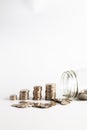 Coins stacked up next to an empty jar with a label on for pension fund. Pension, financial, savings, economy, investment concept Royalty Free Stock Photo