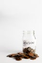 Coins stacked up next to an empty jar with a label on for pension fund. Pension, financial, savings, economy, investment concept Royalty Free Stock Photo