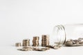 Coins stacked up next to a half empty jar with coins in and with a label on saying pension fund. Pension, financial, savings, Royalty Free Stock Photo