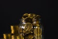 Coins stacks and gold coin money in the glass jar on dark background, for saving for the future banking finance concept. Royalty Free Stock Photo