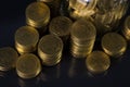 Coins stacks and gold coin money in the glass jar on dark background, for saving for the future banking finance concept. Royalty Free Stock Photo