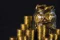 Coins stacks and gold coin money in the glass jar on dark backgr Royalty Free Stock Photo