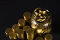 Coins stacks and gold coin money in the glass jar on dark background, for saving for the future banking finance concept. Royalty Free Stock Photo