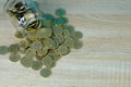 Coins stacks and gold coin money in the glass jar on table with Royalty Free Stock Photo