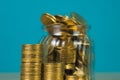 Coins stacks and gold coin money in the glass jar on table with Royalty Free Stock Photo