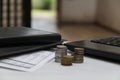 Coins on the table, with laptops and financial reports, version 3