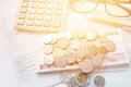 Coins, Thai money, pen, calculator, glasses and savings account passbook on white background Royalty Free Stock Photo