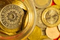 Coins of the various countries in a glass jar. metal coins of different denominations. finance background Royalty Free Stock Photo