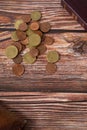 Coins on wooden background with holy bible book and wallet, vertical shot, copy space, top view, Christian tithing concept Royalty Free Stock Photo