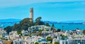 Coit Tower on Telegraph Hill aerial overlooking San Francisco Bay with houses and apartments