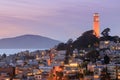 Coit Tower on Telegraph Hill with San Francisco Bay and Angel Island in the background at dusk. Royalty Free Stock Photo