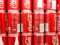 Coke coca cola classic cans cases stacked in supermarket background pattern