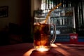 Coke inglass with straw. Brown sparkling beverage with sun backlight. Sparkling drink with ice in glass