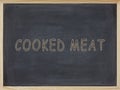 Coked meat written in yellow on a blackboard