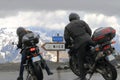 Motor bikers near signposting at Col de la Bonette, France Royalty Free Stock Photo