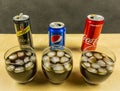 A cola carbonated drink made by Pepsi, Coca-Cola and Schweppes. presented in glasses with ice cubes.