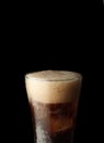 Cola glass with ice cubes and bubbles. Cold sweet drink on black background Royalty Free Stock Photo