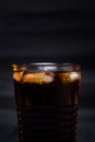 Cola glass with ice cubes and droplets, isolated on black background Royalty Free Stock Photo